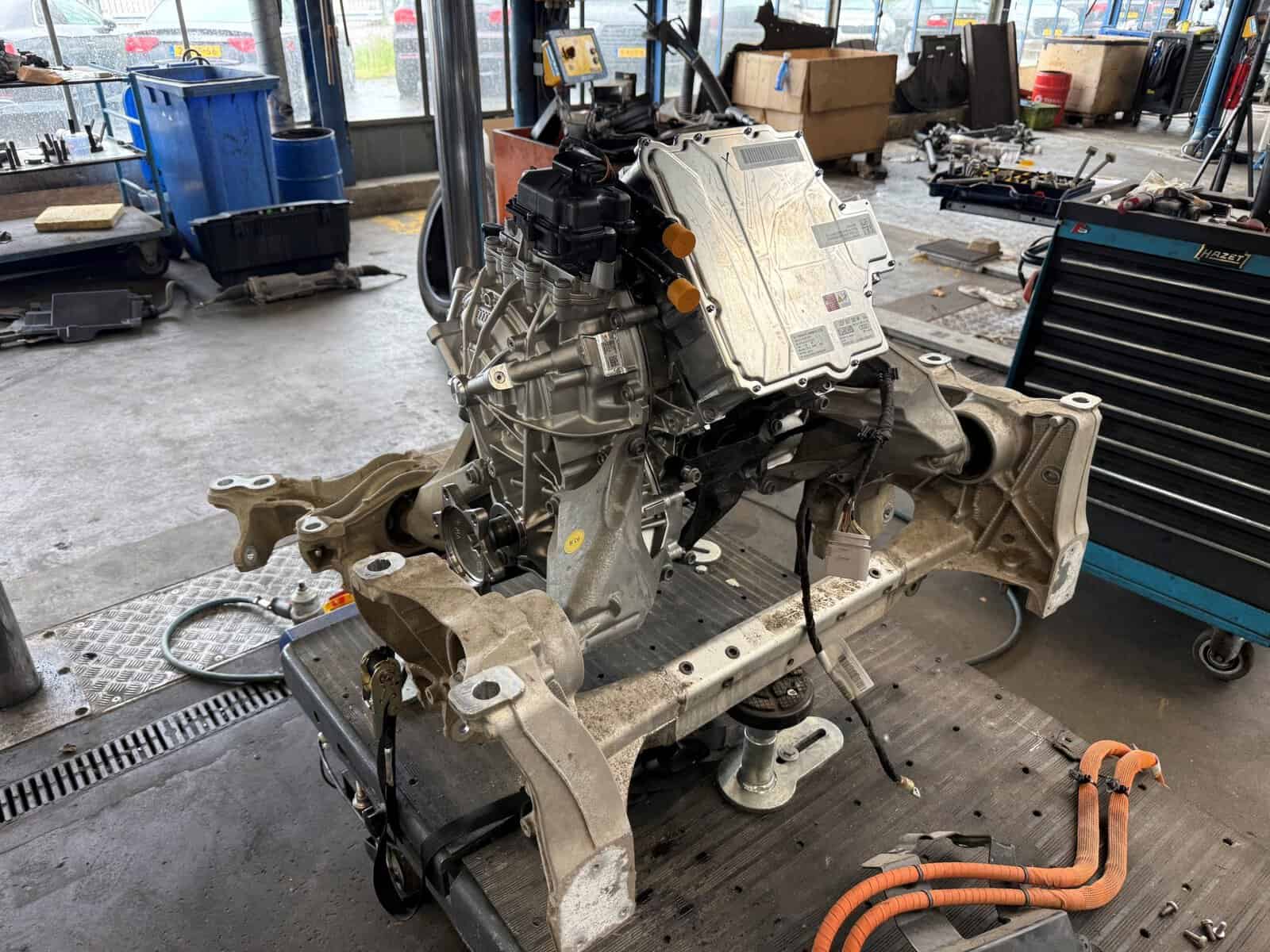 Motorblok en transmissie van een auto in werkplaats, klaar voor montage of reparatie.